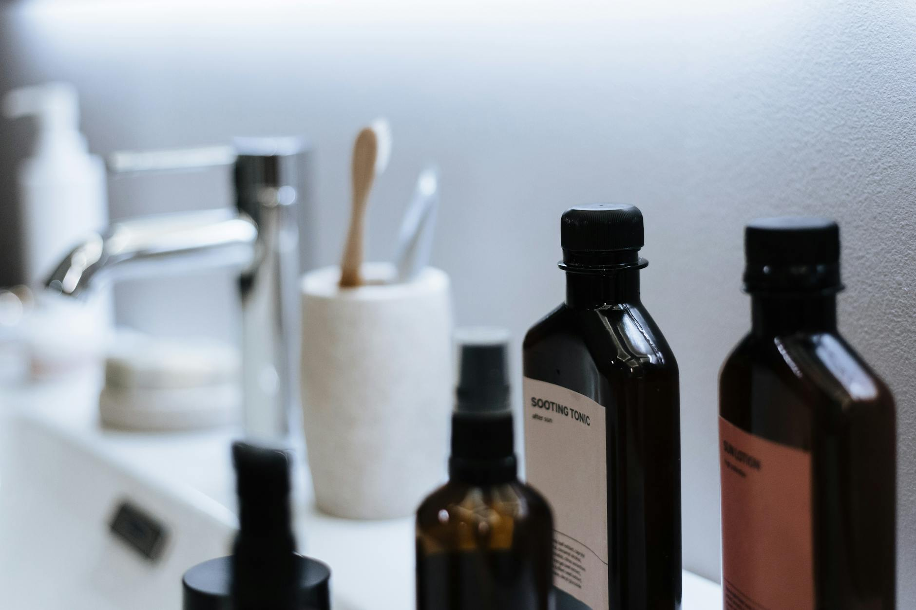 Eine Frau mit natürlicher Haut genießt das Morgenlicht am Fenster, umgeben von frischem Obst und Gemüse, die für eine gesunde Hautpflege stehen.